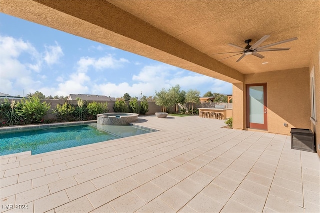 view of pool with an in ground hot tub, an outdoor bar, ceiling fan, and a patio