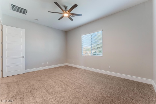 empty room featuring carpet flooring and ceiling fan