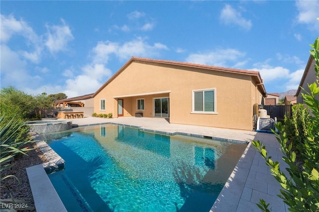 view of swimming pool featuring an in ground hot tub, a patio area, and a bar