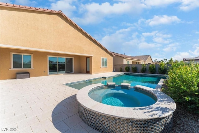 view of pool with an in ground hot tub