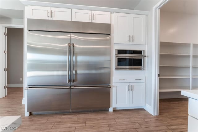 kitchen with stainless steel appliances and white cabinets