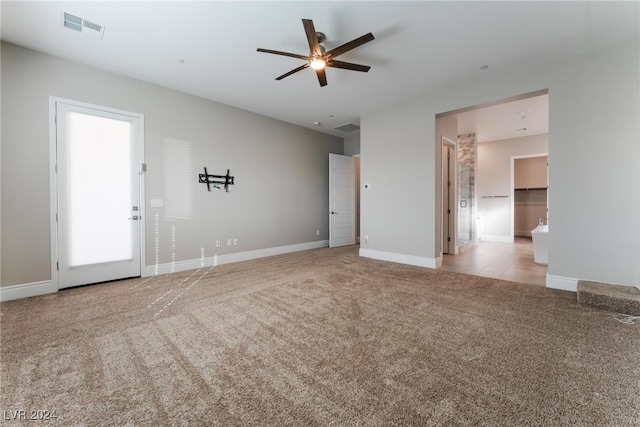 carpeted empty room featuring ceiling fan