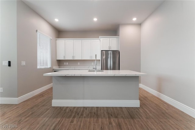 kitchen with sink, white cabinetry, a center island with sink, stainless steel fridge, and dark hardwood / wood-style flooring