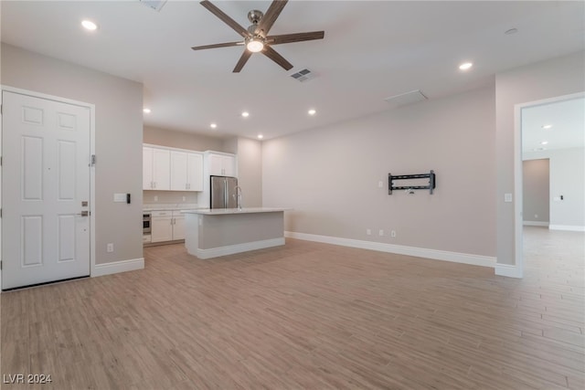 unfurnished living room with light hardwood / wood-style floors and ceiling fan