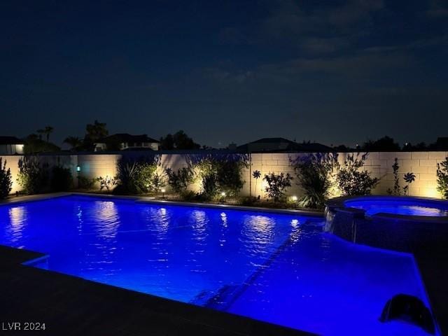 view of pool at night