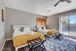 bedroom with ceiling fan, access to exterior, and dark hardwood / wood-style flooring