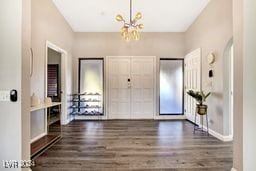 foyer featuring a notable chandelier and dark hardwood / wood-style flooring