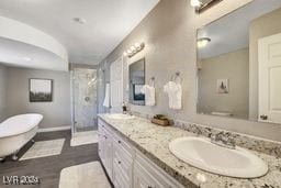 full bathroom with vanity, shower with separate bathtub, hardwood / wood-style floors, and toilet