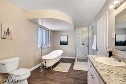 full bathroom with toilet, separate shower and tub, vanity, and wood-type flooring