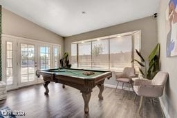 rec room featuring wood-type flooring, billiards, french doors, and vaulted ceiling