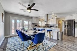 dining area with french doors, light hardwood / wood-style flooring, and ceiling fan