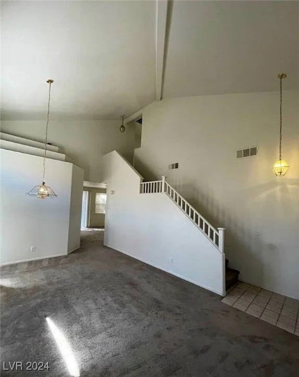 interior space featuring carpet floors, beamed ceiling, and high vaulted ceiling