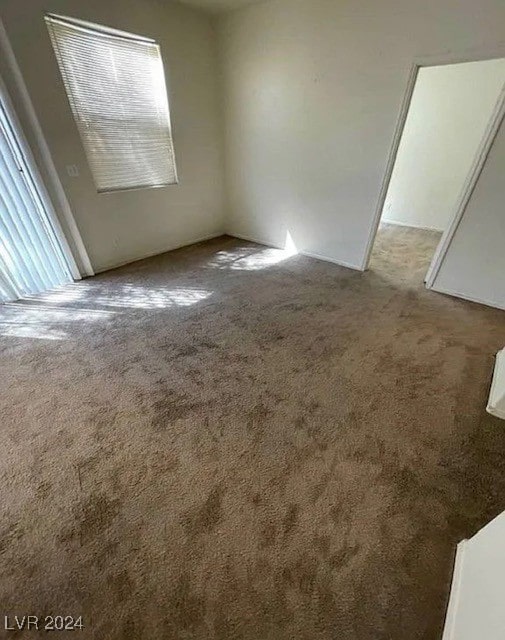 carpeted spare room with plenty of natural light