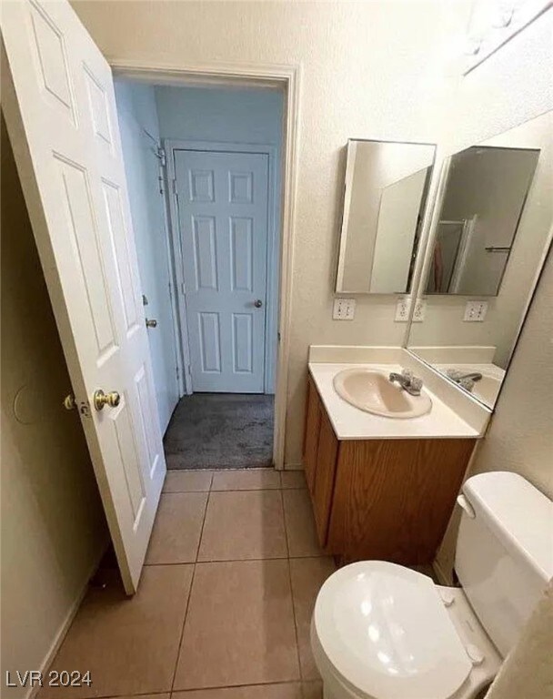 bathroom featuring vanity, toilet, and tile patterned floors