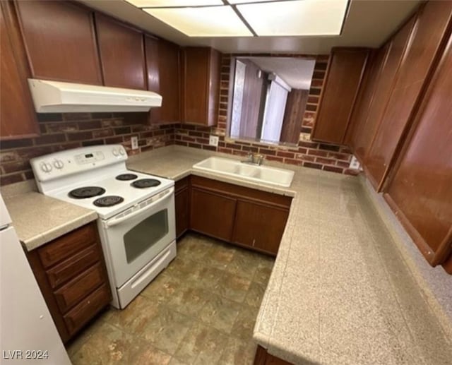 kitchen featuring sink, decorative backsplash, and white range with electric cooktop