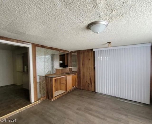 kitchen with dark wood-type flooring and a textured ceiling