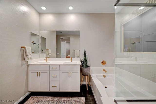 bathroom with vanity and separate shower and tub