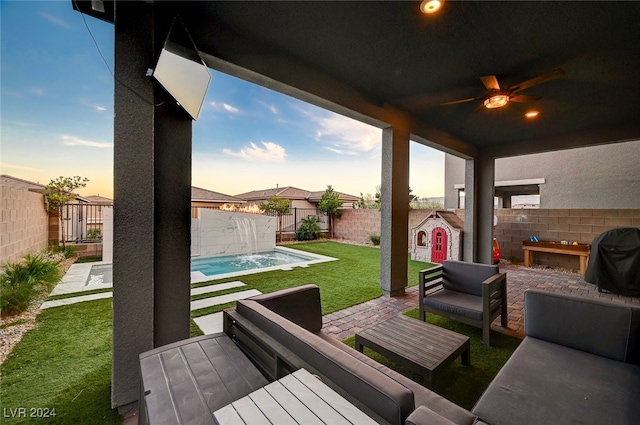 patio terrace at dusk featuring an outdoor living space, ceiling fan, a fenced in pool, grilling area, and pool water feature