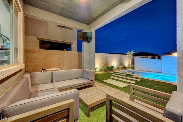 view of patio / terrace featuring a fenced in pool and an outdoor living space