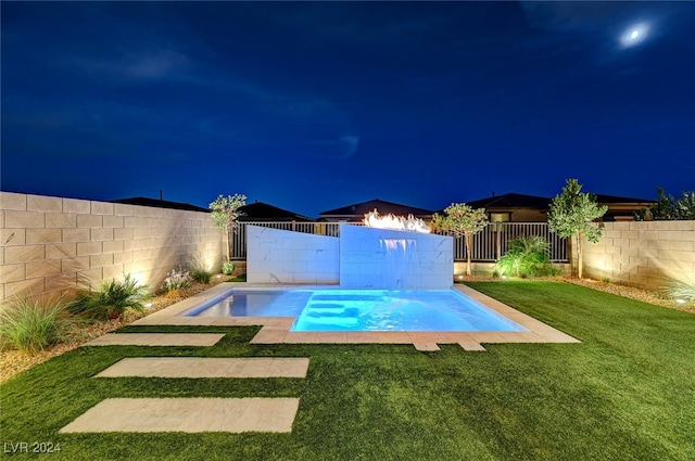 pool at night with a yard