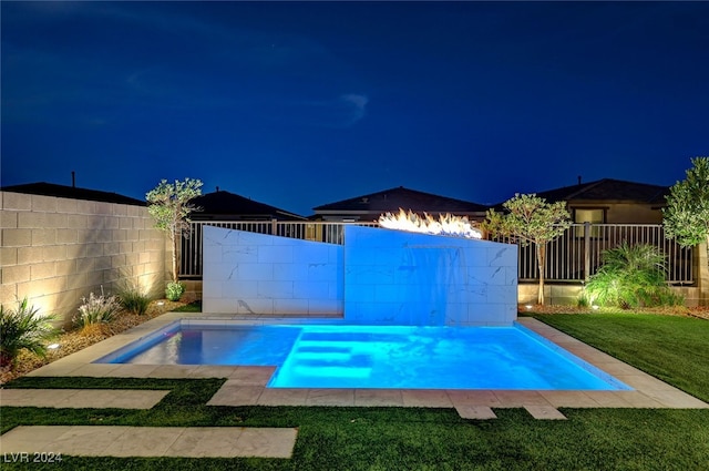 pool at twilight featuring a lawn