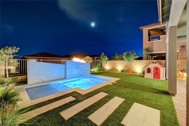 pool at twilight featuring a yard