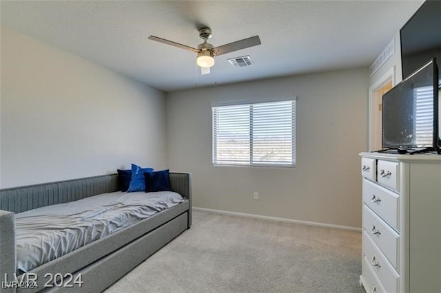 bedroom with ceiling fan and light colored carpet