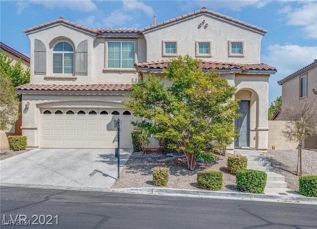 mediterranean / spanish-style house featuring a garage