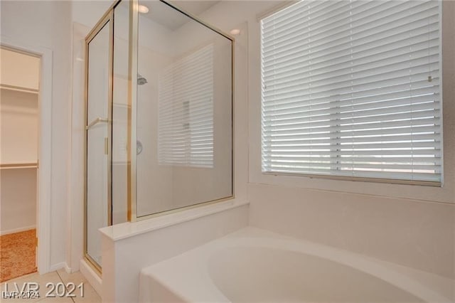 bathroom featuring shower with separate bathtub and tile patterned floors