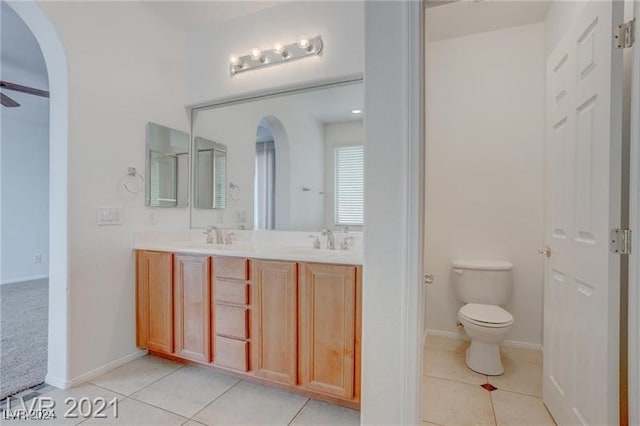 bathroom with ceiling fan, vanity, toilet, and tile patterned floors