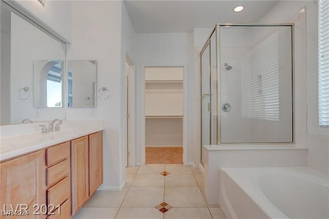 bathroom with vanity, plus walk in shower, and tile patterned flooring