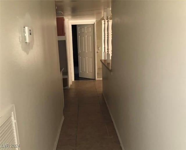 hall with dark tile patterned floors