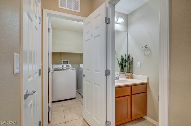 bathroom featuring tile patterned floors, vanity, and washer and clothes dryer