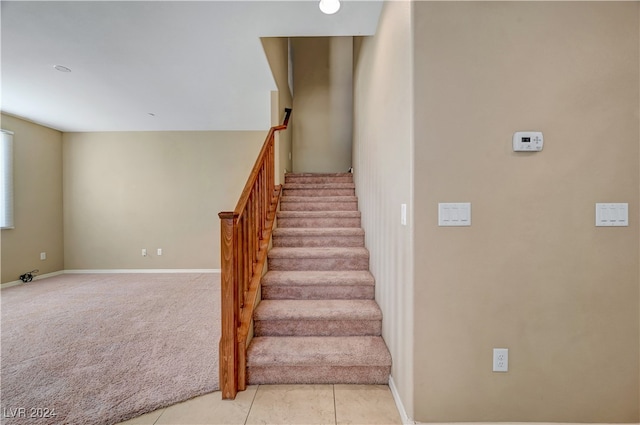 stairs featuring carpet flooring