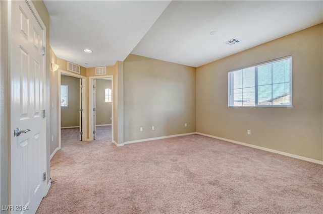 unfurnished room with light carpet