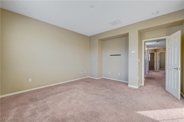 empty room featuring light carpet