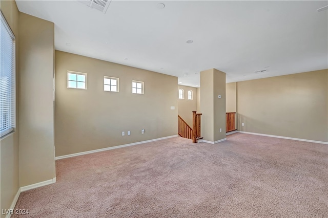 basement featuring light carpet