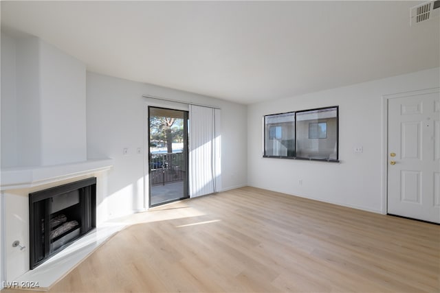 unfurnished living room with light hardwood / wood-style flooring