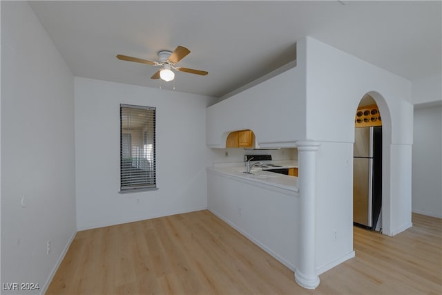 kitchen featuring ceiling fan, stainless steel refrigerator, sink, and light hardwood / wood-style floors