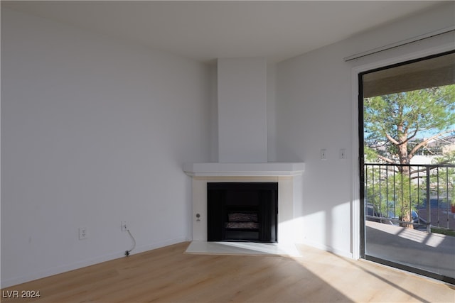 unfurnished living room with wood-type flooring