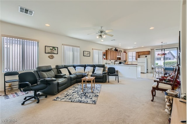 living room with ceiling fan and light colored carpet