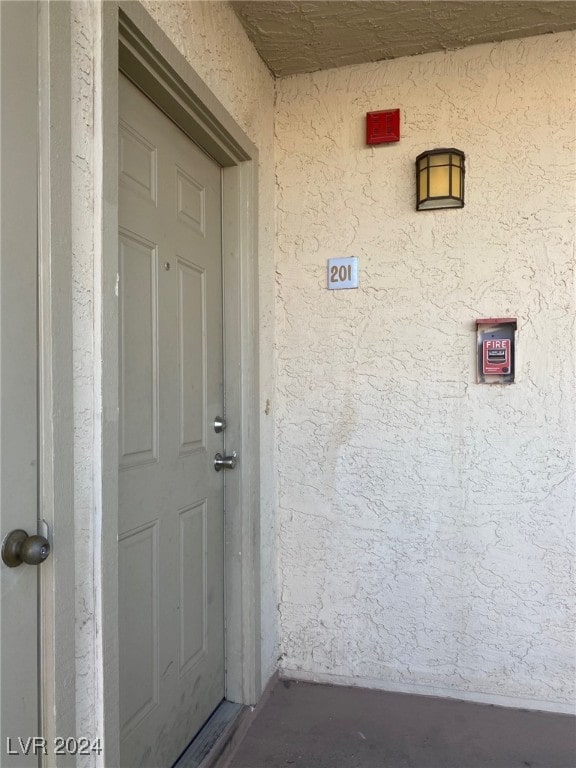 entrance to property with stucco siding