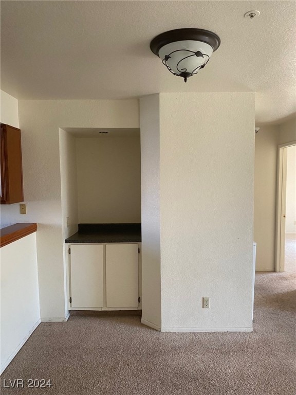 carpeted spare room featuring a textured ceiling