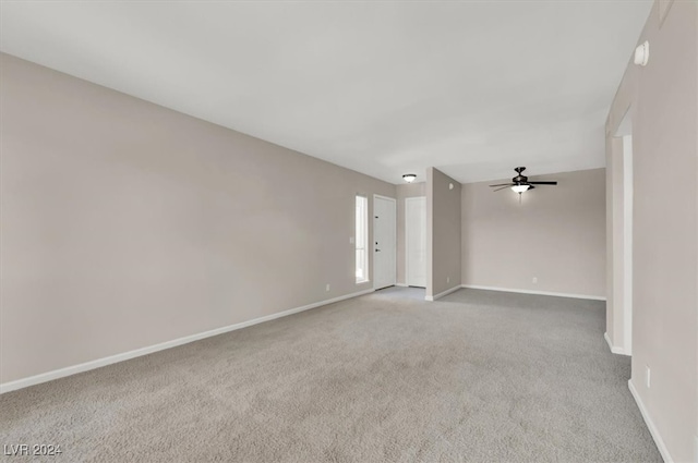 spare room featuring carpet floors and ceiling fan