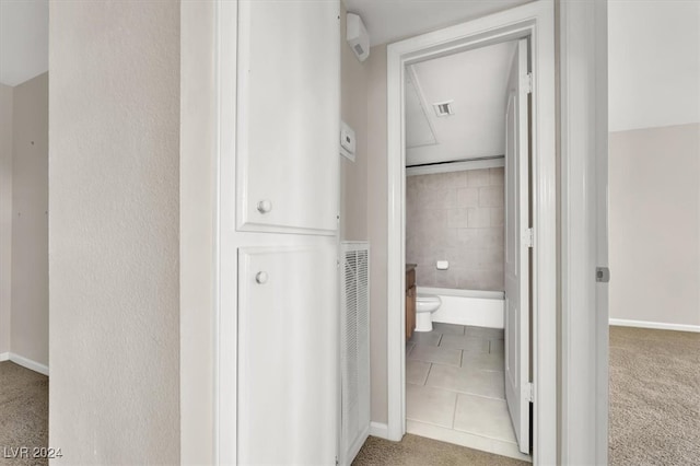 bathroom with toilet and tile patterned floors