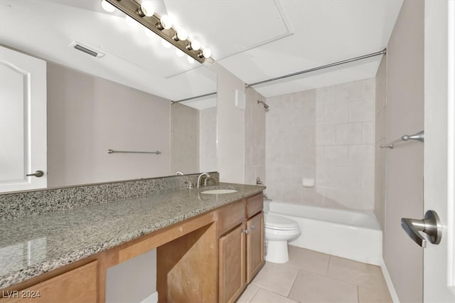 full bathroom with vanity, tiled shower / bath combo, toilet, and tile patterned floors