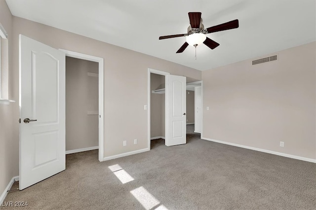 unfurnished bedroom featuring ceiling fan and carpet floors