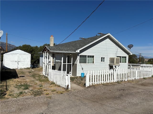 exterior space featuring a shed and central air condition unit