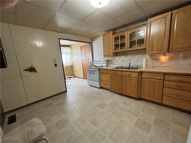 kitchen featuring a drop ceiling, sink, and white electric range