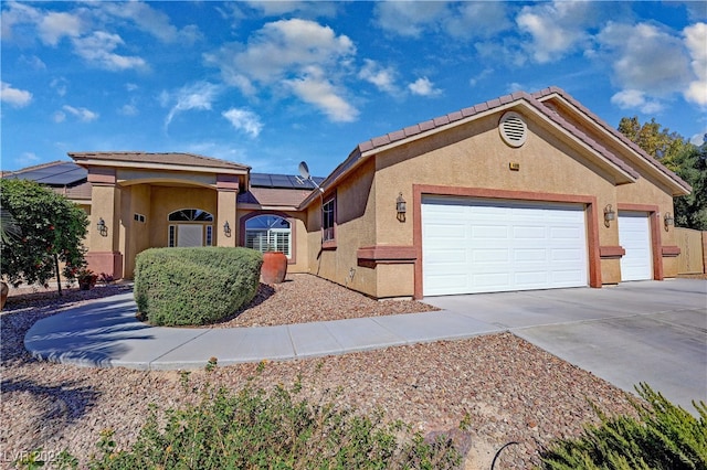 view of front of house with a garage and solar panels